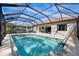 A stunning screened-in pool with lush surroundings offers ultimate privacy at 11981 Hunters Creek Rd, Venice, FL 34293