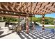 The outdoor seating area is shaded by a pergola, and has multiple tables at 1211 Gulf Of Mexico Dr # 207, Longboat Key, FL 34228