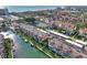 Aerial view showcasing waterfront condos, boats, and community amenities including a tennis court at 1250 N Portofino Dr # 408Mar, Sarasota, FL 34242
