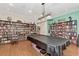 Spacious game room with pool table, bookshelves, and comfortable seating at 1250 N Portofino Dr # 408Mar, Sarasota, FL 34242