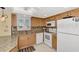 Updated kitchen featuring granite countertops and ample wood cabinetry at 1250 N Portofino Dr # 408Mar, Sarasota, FL 34242