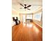 Living room with hardwood floors, a ceiling fan, couch, windows with blinds, a TV, and sliding glass doors at 1250 N Portofino Dr # 408Mar, Sarasota, FL 34242