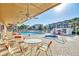 Covered patio overlooking community pool, hot tub, and lounge area at 1250 N Portofino Dr # 408Mar, Sarasota, FL 34242