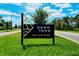 Downtown Wellen Park sign with manicured lawn and a clear blue sky backdrop at 12542 Meribel St, Venice, FL 34293