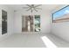 Covered patio area with sliding glass doors and a view of the pool and the lake at 12918 Rainwashed Loop, Parrish, FL 34219