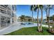 Expansive backyard pool with a jacuzzi, spiral staircase, waterfront views, and well-maintained landscaping at 1400 Siesta Dr, Sarasota, FL 34239