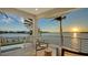 Balcony featuring a spiral staircase and stunning water views at sunset at 1400 Siesta Dr, Sarasota, FL 34239