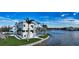 Modern waterfront home with a rooftop patio, lush landscaping, private dock, and stunning water views at 1400 Siesta Dr, Sarasota, FL 34239