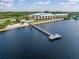 Aerial of a waterfront property with a long pier, boat dock, sandy beach, and community pool at 14459 River Beach Dr # 218, Port Charlotte, FL 33953