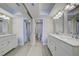 Bathroom featuring double sinks, marble countertops, ample lighting, and neutral paint at 14459 River Beach Dr # 218, Port Charlotte, FL 33953