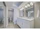 Bright bathroom with double sinks, marble countertops, and a glass-enclosed shower at 14459 River Beach Dr # 218, Port Charlotte, FL 33953
