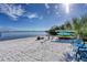 A peaceful beachfront with kayaks, lounge chairs, and sunny skies near the water at 14459 River Beach Dr # 218, Port Charlotte, FL 33953