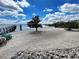 Secluded beach area with a tranquil shoreline and mature trees at 14459 River Beach Dr # 218, Port Charlotte, FL 33953