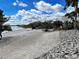 Scenic view of a white sand beach with lush landscaping and calm waters at 14459 River Beach Dr # 218, Port Charlotte, FL 33953