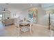 Cozy dining area with a round table, white chairs, and beach-themed decor at 14459 River Beach Dr # 218, Port Charlotte, FL 33953