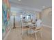 Dining room with a round table, decorative chairs and beach-themed decor at 14459 River Beach Dr # 218, Port Charlotte, FL 33953