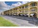 Wide shot of a multi-Gathering building with a parking area on the ground level at 14459 River Beach Dr # 218, Port Charlotte, FL 33953