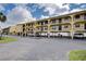 Exterior shot of a multi-story complex with covered parking and waterfront views at 14459 River Beach Dr # 218, Port Charlotte, FL 33953