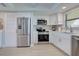 Updated kitchen with stainless steel appliances and modern cabinets at 14459 River Beach Dr # 218, Port Charlotte, FL 33953
