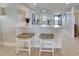 Stylish kitchen with white cabinets, stainless steel appliances, and breakfast bar with seating at 14459 River Beach Dr # 218, Port Charlotte, FL 33953