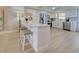 Modern kitchen featuring white cabinetry, stainless steel appliances, and breakfast bar with stylish seating at 14459 River Beach Dr # 218, Port Charlotte, FL 33953