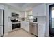 Contemporary kitchen featuring stainless steel appliances and stylish cabinetry at 14459 River Beach Dr # 218, Port Charlotte, FL 33953