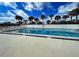 Inviting community pool with palm trees and clear blue water at 14459 River Beach Dr # 218, Port Charlotte, FL 33953