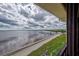 Balcony view showcasing expansive waterfront and pier on a cloudy day at 14459 River Beach Dr # 218, Port Charlotte, FL 33953