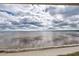 Expansive water view from the property showcases an inviting dock and cloudy skies at 14459 River Beach Dr # 218, Port Charlotte, FL 33953