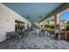 Inviting outdoor dining area featuring patio tables, chairs, and beautiful landscaping at 14659 Derna Ter, Bradenton, FL 34211