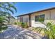 Backyard with a screen porch, paver patio, well-maintained landscaping and partial fence at 1709 Curry Trl # 30, Nokomis, FL 34275
