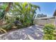 Landscaped backyard with a paver patio area, mature trees, and a privacy fence at 1709 Curry Trl # 30, Nokomis, FL 34275