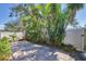 Private backyard featuring a paver patio surrounded by lush landscaping and a white fence at 1709 Curry Trl # 30, Nokomis, FL 34275