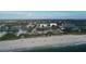 Scenic beach view with white sand, blue water, and coastal homes in the background at 1709 Curry Trl # 30, Nokomis, FL 34275