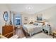 Cozy bedroom with neutral decor, a window with curtains, and comfortable furnishings at 1709 Curry Trl # 30, Nokomis, FL 34275