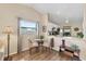 Dining area with a glass table, neutral chairs, and a view into the updated kitchen at 1709 Curry Trl # 30, Nokomis, FL 34275