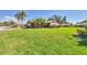 Well-maintained front yard with lush green grass, mature trees, and neatly trimmed hedges at 1709 Curry Trl # 30, Nokomis, FL 34275