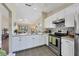Bright kitchen with stainless steel appliances, tile backsplash, and open view to the living area at 1709 Curry Trl # 30, Nokomis, FL 34275