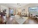 Bright living room with wood floors, comfortable seating, and sliding glass doors to the outside at 1709 Curry Trl # 30, Nokomis, FL 34275