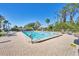 Community pool area with lounge chairs and clear blue water on a bright sunny day at 1709 Curry Trl # 30, Nokomis, FL 34275