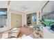 Bright sunroom with wicker seating, a ceiling fan, and a sliding door leading to a patio at 1709 Curry Trl # 30, Nokomis, FL 34275