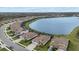Gorgeous aerial view of a neighborhood with waterfront properties, lush landscaping, and expansive blue lake in background at 17610 Polo Trl, Bradenton, FL 34211