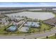 Community aerial view showcasing the clubhouse, pool, tennis courts, and scenic lakes at 17610 Polo Trl, Bradenton, FL 34211