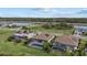 Aerial view of homes with screened in pools and solar panels, as well as sunset views and lush lawns at 17610 Polo Trl, Bradenton, FL 34211