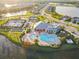 Breathtaking aerial view of a community featuring a pool, tennis courts, clubhouse and beautiful lakes at 17610 Polo Trl, Bradenton, FL 34211