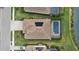 Aerial view of single-Gathering home featuring modern tile roof, solar panels, screened pool and lush green landscape at 17610 Polo Trl, Bradenton, FL 34211