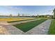 Well-maintained bocce ball court with lush artificial turf, offering a fun outdoor activity by the water at 17610 Polo Trl, Bradenton, FL 34211