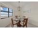 Cozy dining area features a round glass table, seating for four, and a view of the waterfront at 17610 Polo Trl, Bradenton, FL 34211