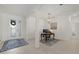 Bright home foyer with a chandelier, stylish rug, and decorative glass door at 17610 Polo Trl, Bradenton, FL 34211