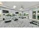Modern gym with treadmills, TVs, and large windows offering scenic views for an enjoyable workout at 17610 Polo Trl, Bradenton, FL 34211